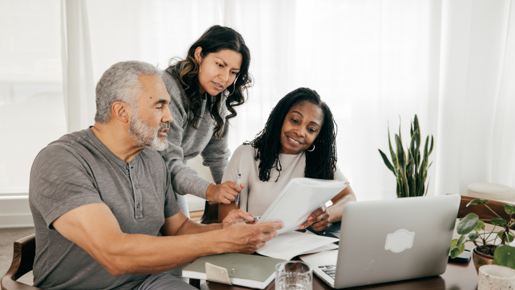 people gather around to use mortgage refinance calculator